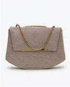 Beige handbag with a gold chain strap on a white background