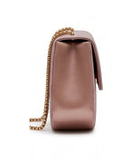 Pink handbag with a gold chain on a white background