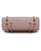 Pink glittery handbag with gold chain straps on a white background