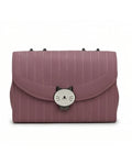 Pink striped handbag with a cat-shaped clasp on a white background