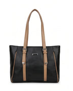 Black handbag with brown straps on a white background