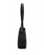 Black handbag with a strap on a white background