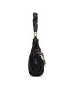 Black leather handbag with a long handle on a white background