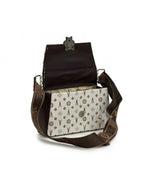 Brown leather handbag with a patterned interior on a white background