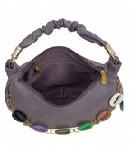 Purple handbag with decorative chain and colorful accents on a white background