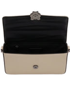 Beige handbag with black interior on a white background