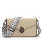 Beige handbag with a gray and white zigzag strap on a white background