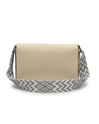 Beige handbag with a gray and white geometric patterned strap on a white background