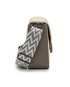 Gray and beige bag with a zigzag patterned strap on a white background