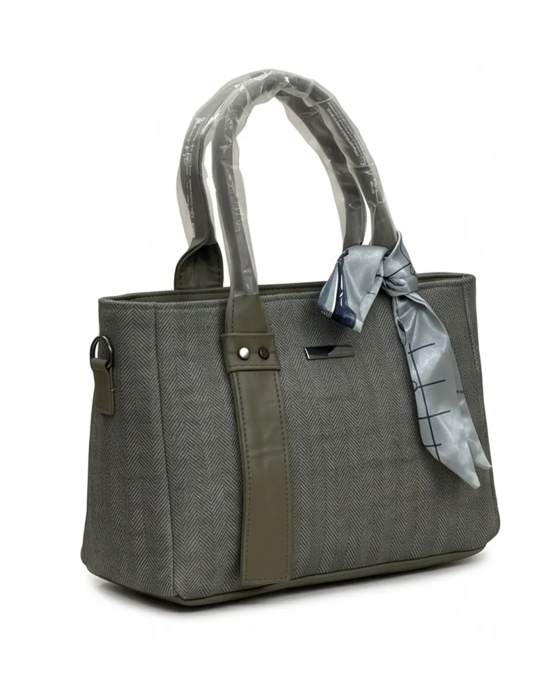 Gray handbag with a green strap and a gray scarf tied around the handle on a white background