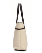 Beige tote bag with black straps on a white background