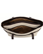 Open handbag showing interior with a white flap and brown lining on a white background