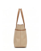 Beige woven handbag with brown leather straps on a white background