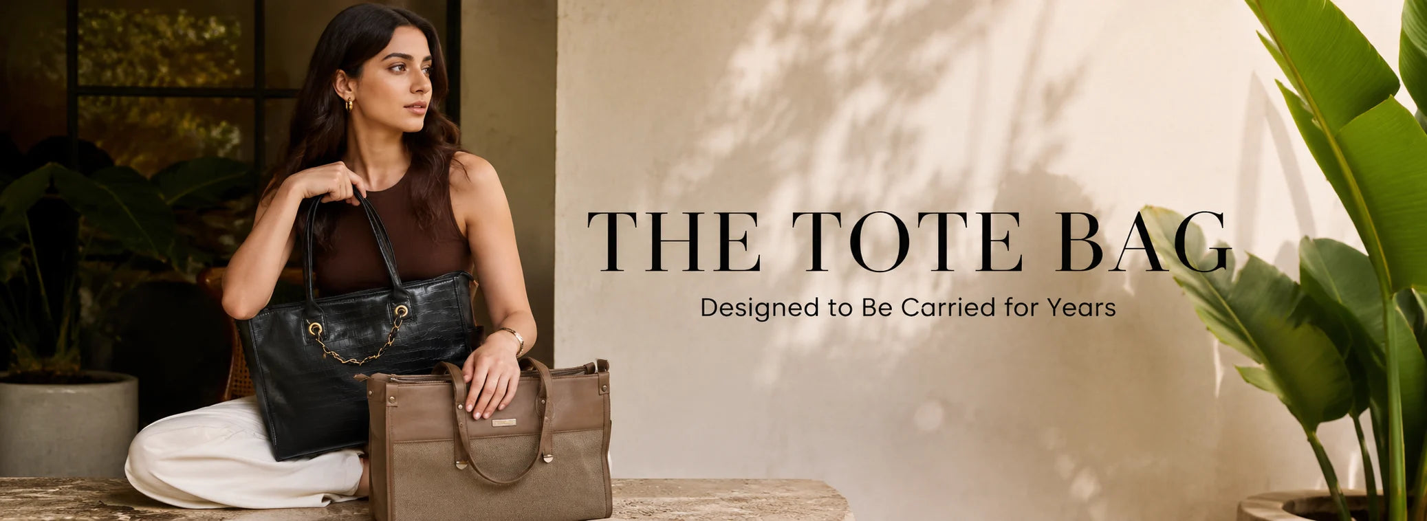 Woman holding a tote bag with text 'The Tote Bag' and tagline 'Designed to be carried for years' against a neutral background.