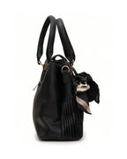 Black leather handbag with a gold clasp on a white background