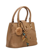 Brown handbag with a fur pom-pom and decorative strap on a white background