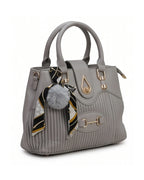 Gray handbag with a pom-pom and scarf detail on a white background