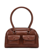 Brown handbag with two front pockets on a white background