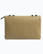 Beige handbag with black zippers on a white background