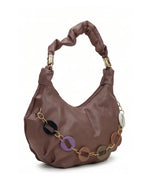 Brown handbag with decorative chain and circular accents on a white background